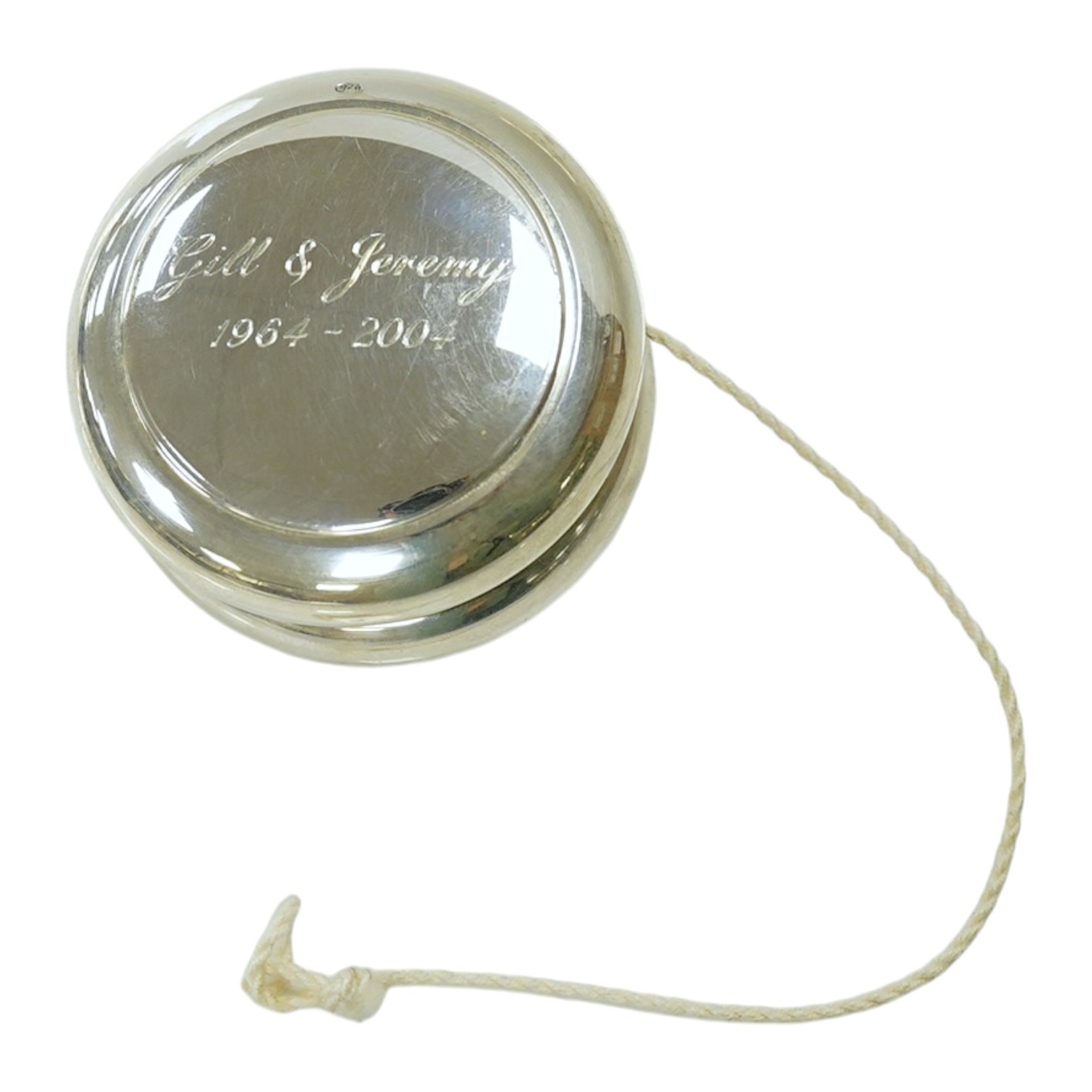 A modern silver mounted yo-yo, Practical Silverware, London, 2003, 56mm, with engraved inscription. Condition - fair to good